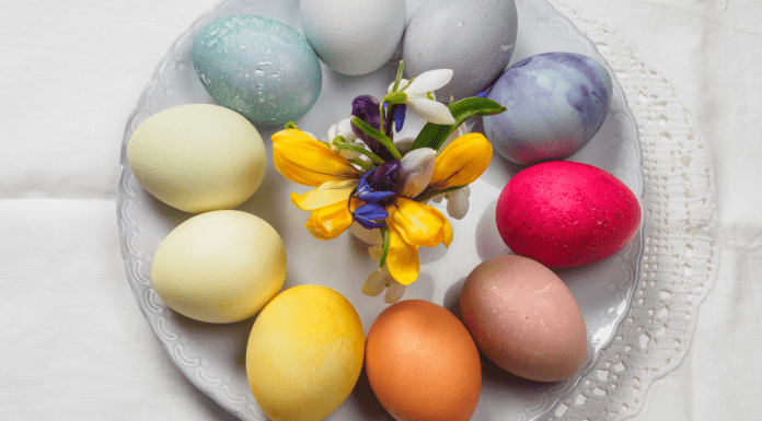 A plate of Easter eggs that have been dyed using natural ingredients - making them yellow, blue, and deep pink.