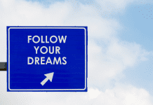 Blue sign that says 'Follow Your Dreams'