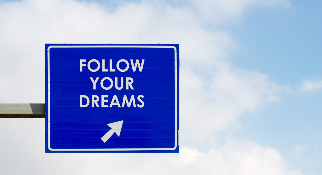 Blue sign that says 'Follow Your Dreams'