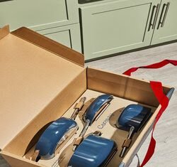 An open box with blue pots and pans inside.