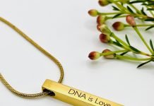 A beautiful gold piece of jewelry that says 'DNA is love'